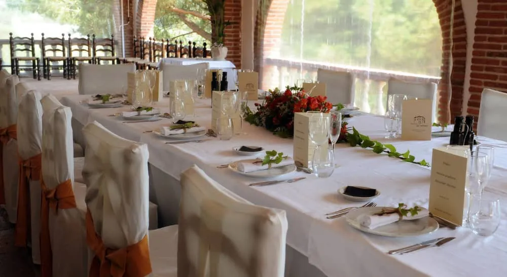 Large indoor room at Can Tarranc set for dinner