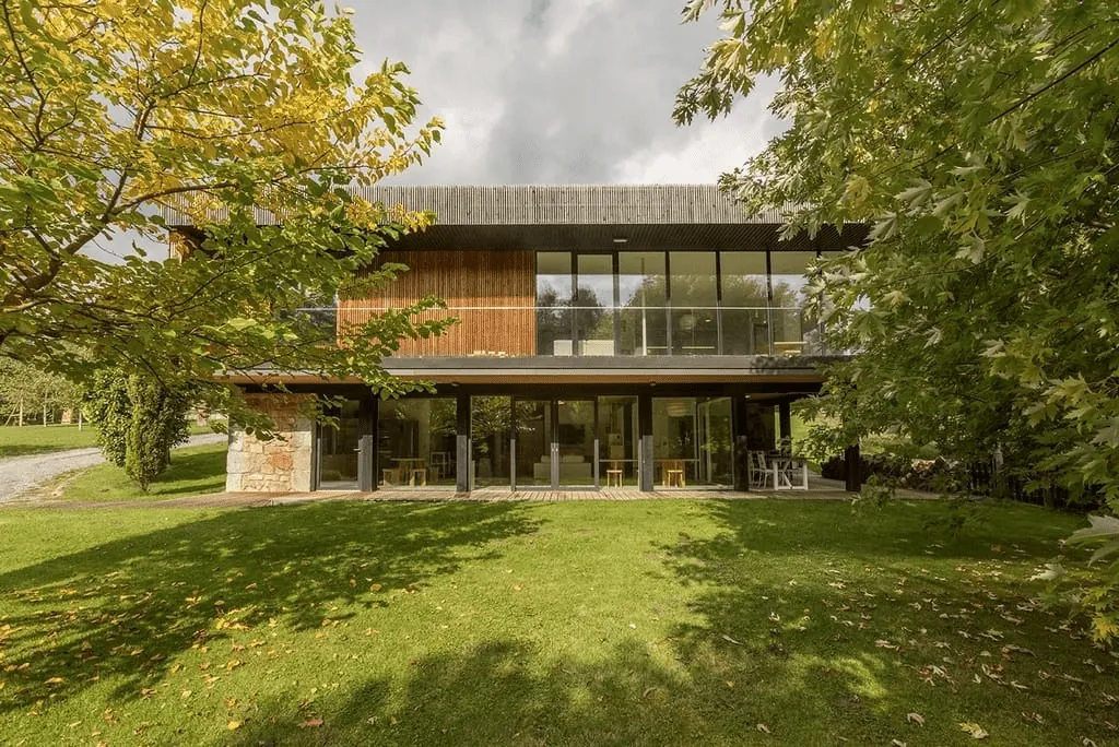 Glass-fronted design house on a lawn at Casas de Ea Astei near Bilbao