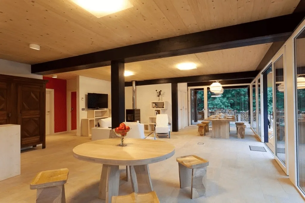 Bright dining room with round wooden table at Casas de Ea Astei near Bilbao