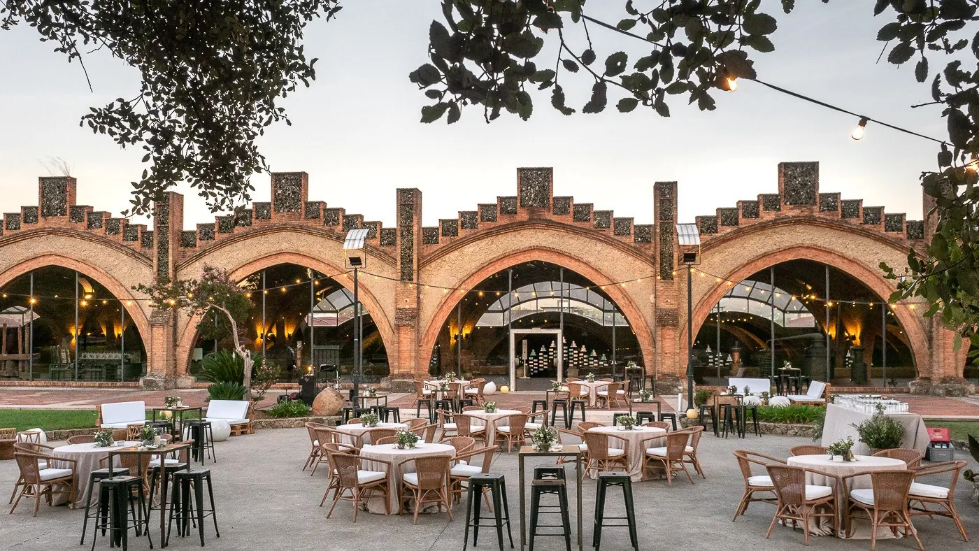Brick arches and garden of Cavas Codorníu in Barcelona at dusk for a corporate event