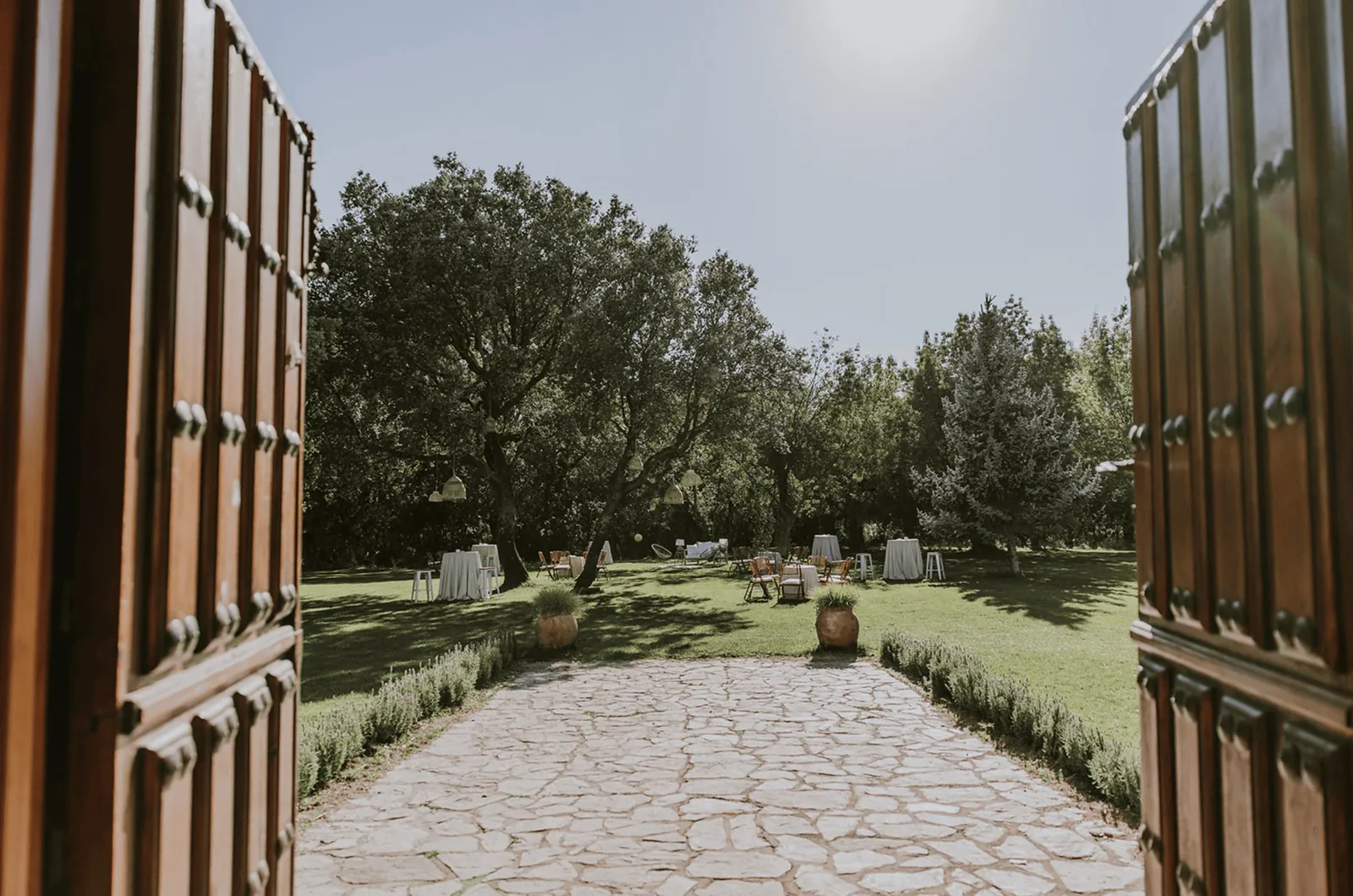 Wooden gate open onto the garden and stone path at Dehesa de Abantos near Madrid