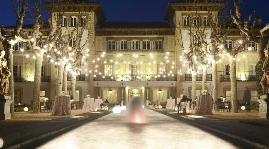 Illuminated facade of Finca Mas Solers near Barcelona in the evening, for corporate events