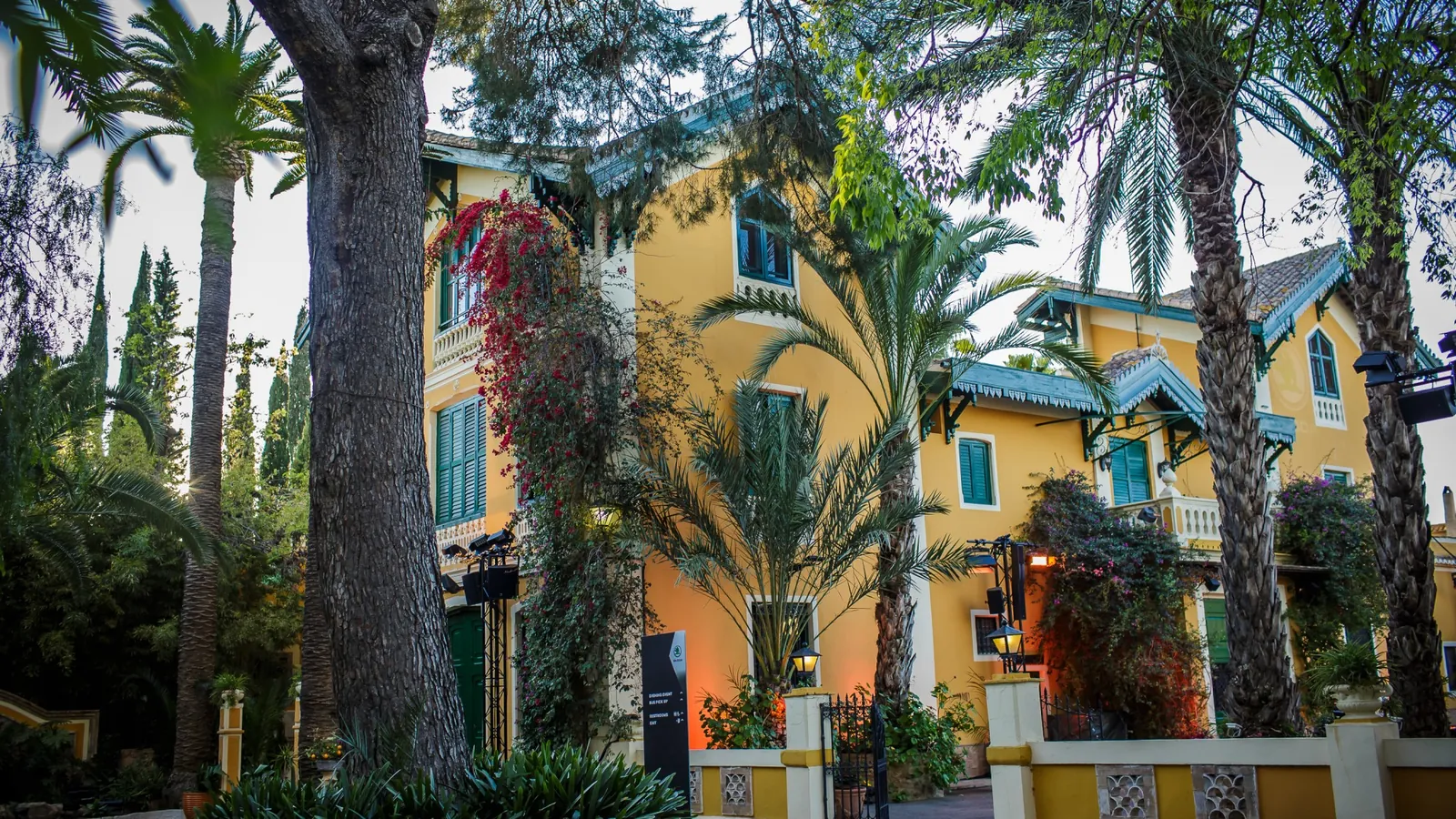 Yellow façade of the masía among the trees