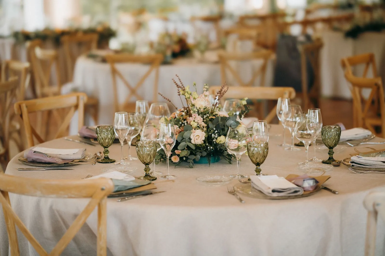 Table setting with glassware and flowers in a hall