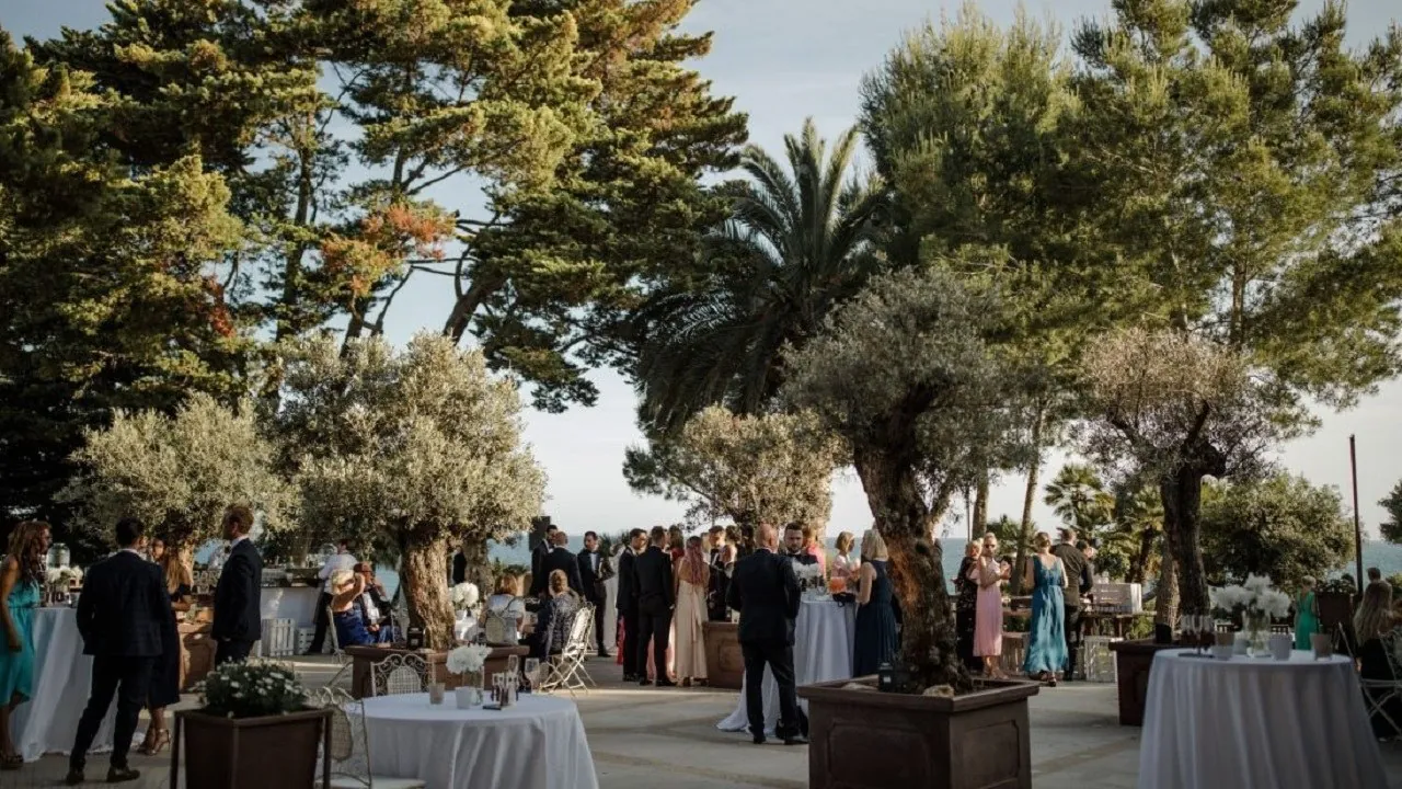 Dinner under the pines at Xalet del Nin, tables set in the garden